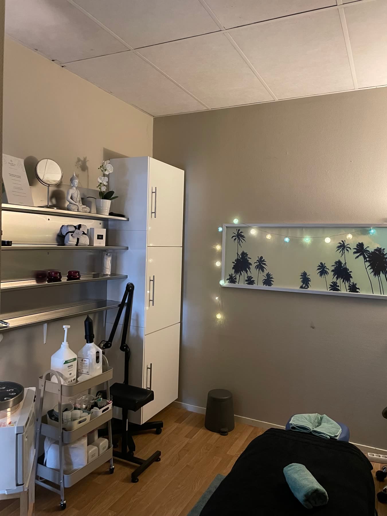 Behandlingsrummet med behandlingsbänk, filt och en tänd ljuslykta